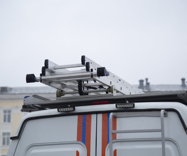 A rescue vehicle with a ladder on the roof.A special car for a group of rescuers.